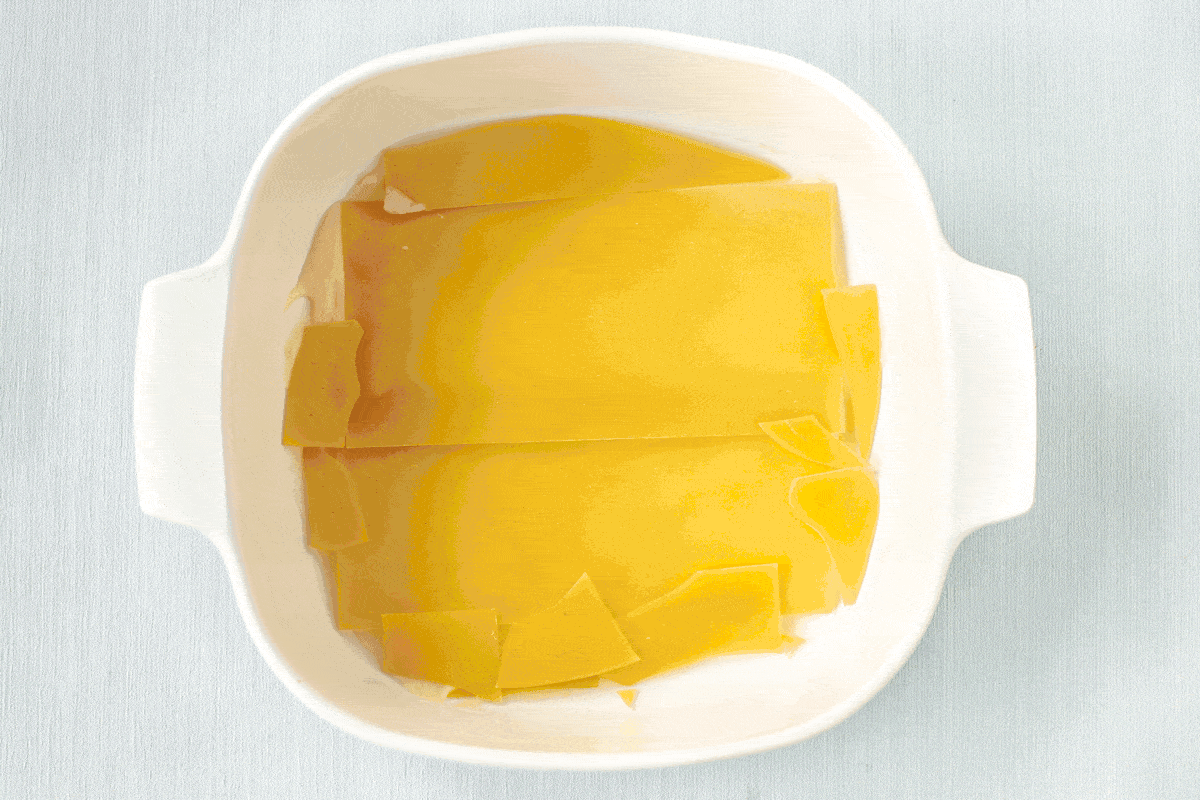 A gif showing how to layer up a creamy vegetable lasagne.