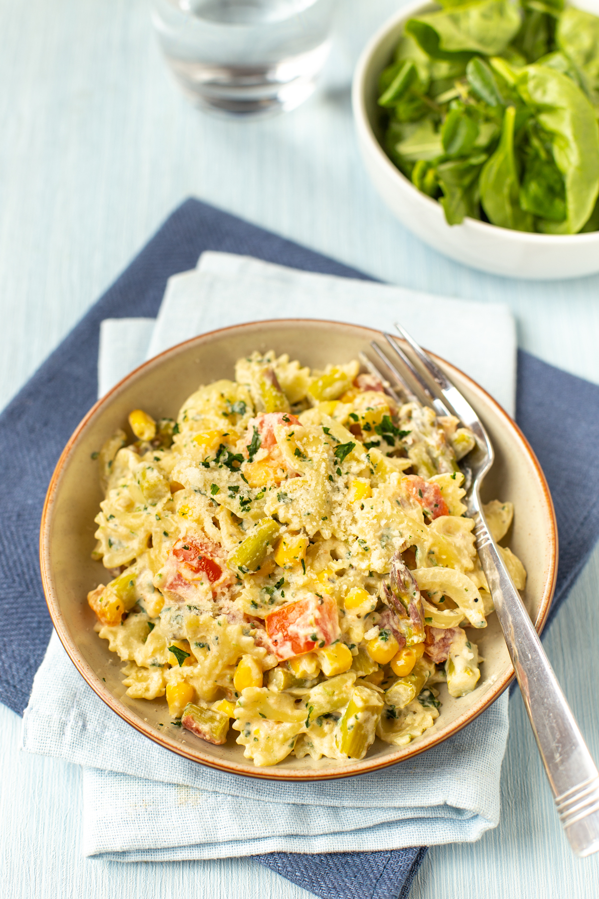 A portion of pasta primavera in a bowl.