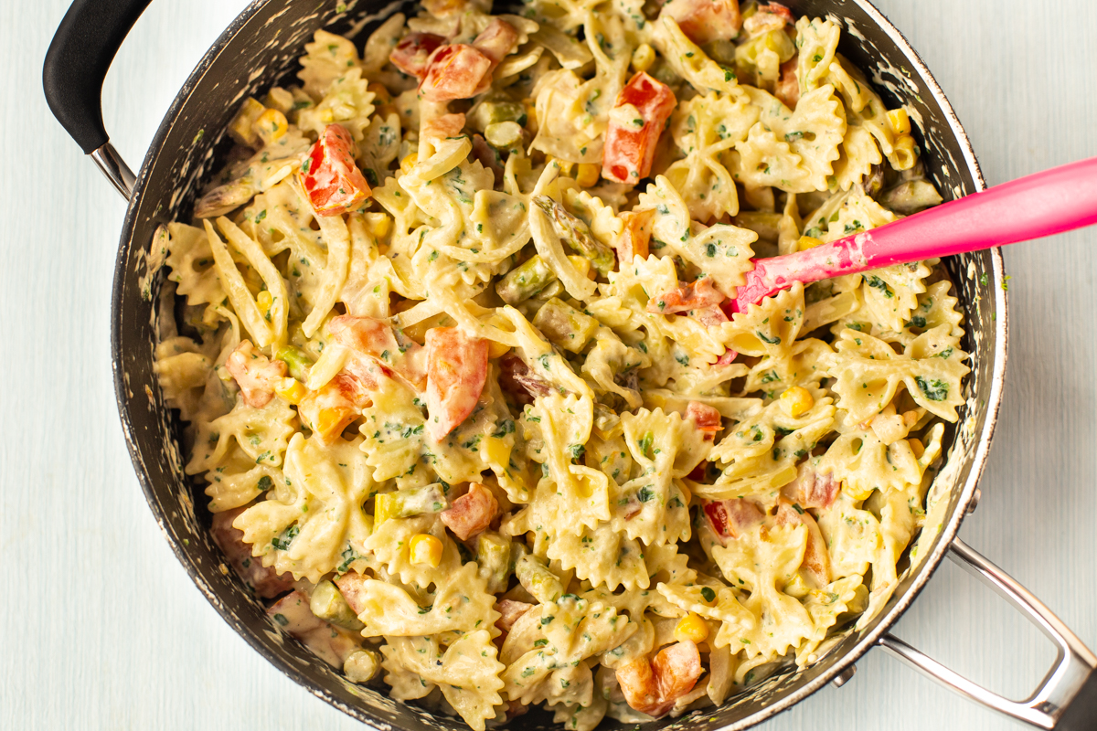 Creamy pasta primavera in a pan.
