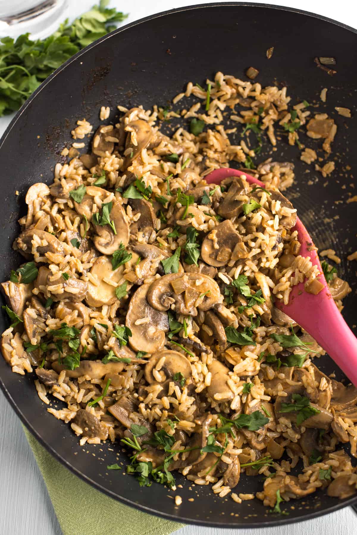 Creamy mushroom stroganoff mixed with rice in a frying pan