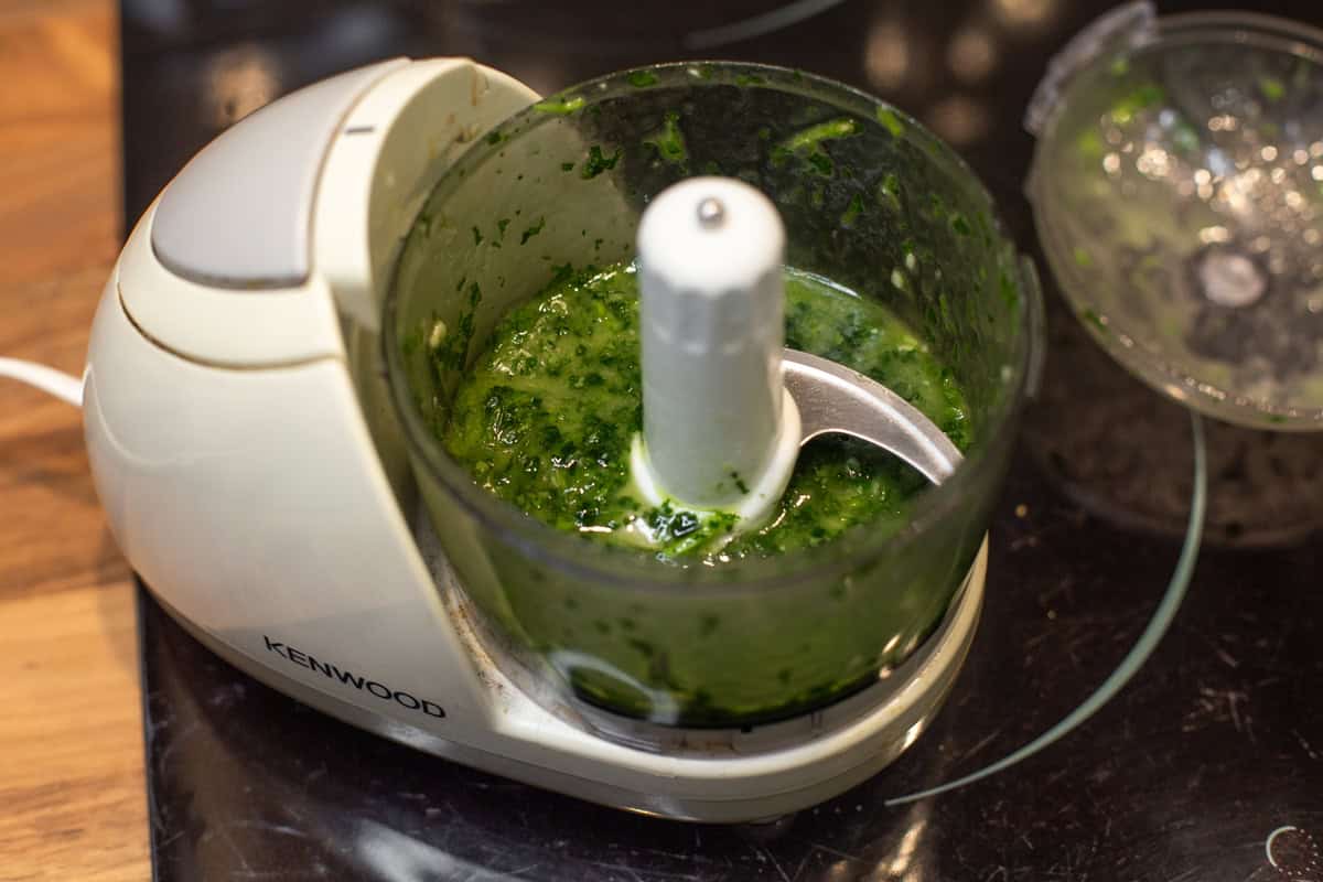 A green dressing in a small food processor.