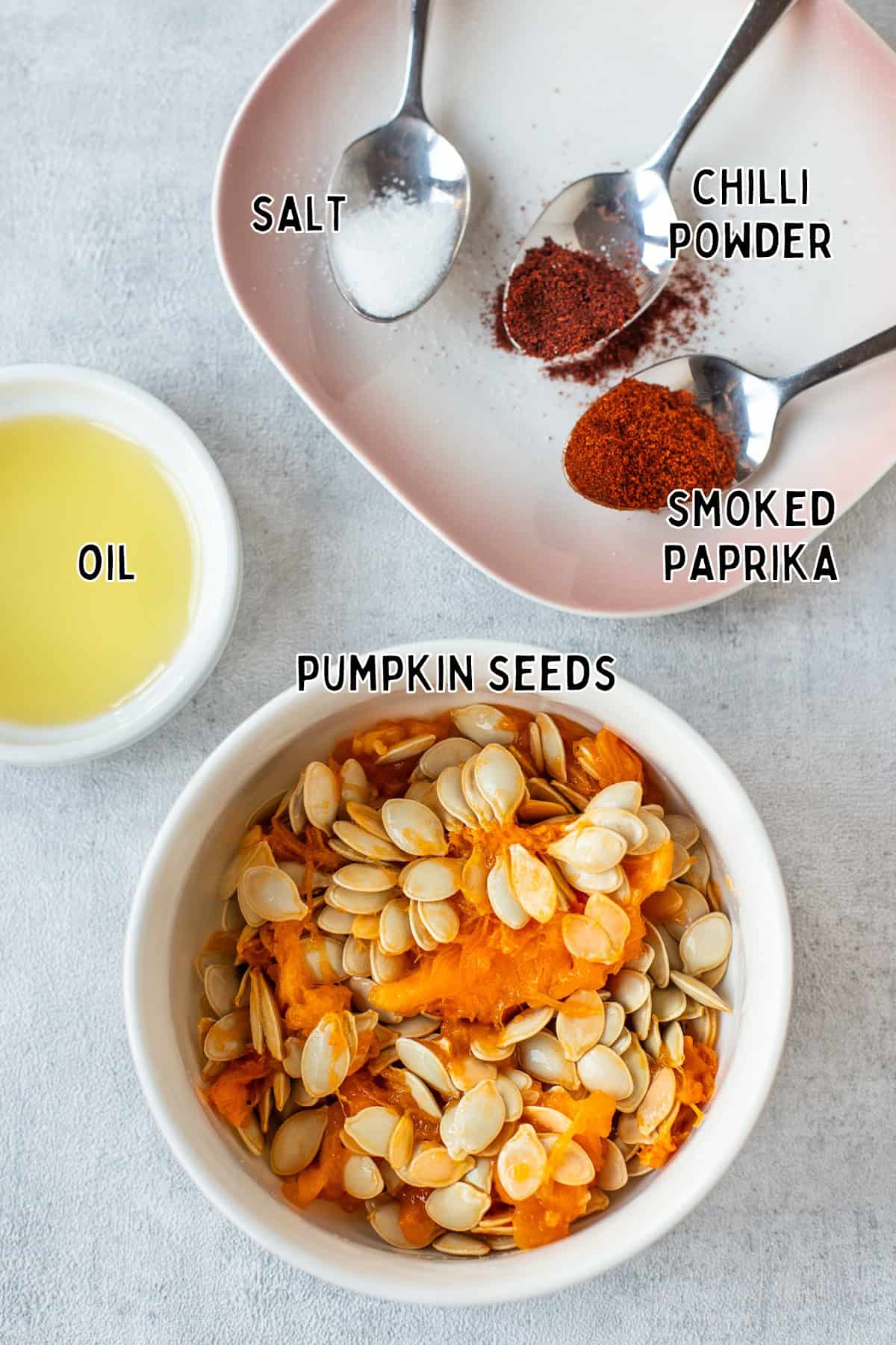 Ingredients for air fryer pumpkin seeds laid out with text overlay.