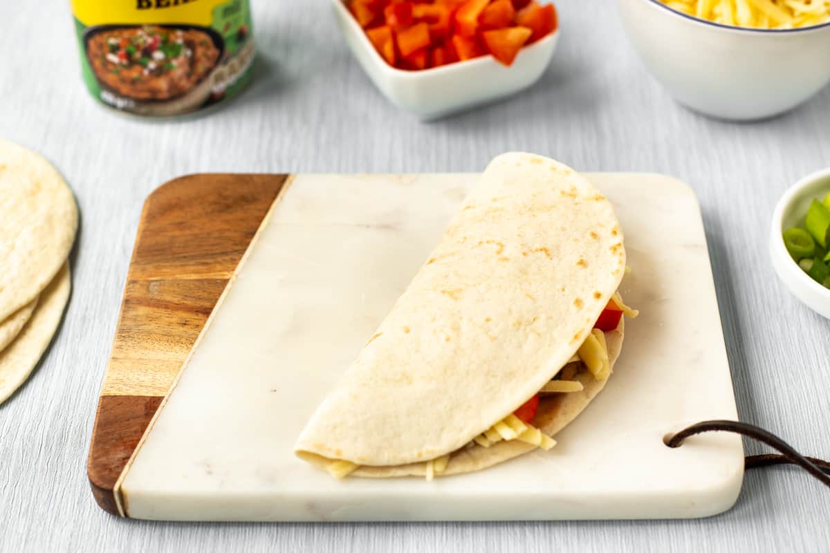 An uncooked vegetarian quesadilla.