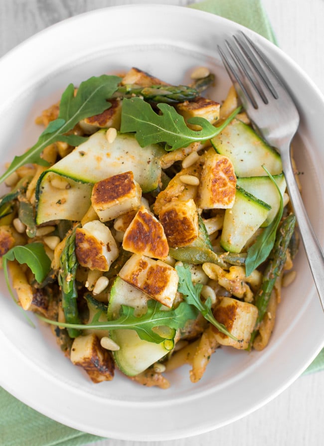 A bowlful of smoky tomato pasta with asparagus and grilled halloumi.