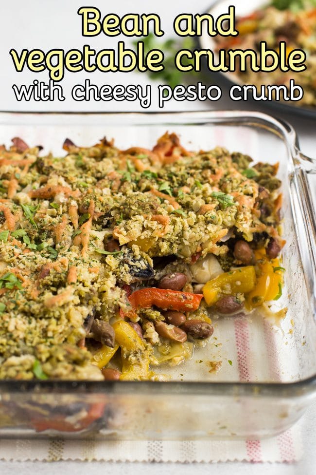 Bean and vegetable crumble in a Pyrex baking dish with a scoop removed