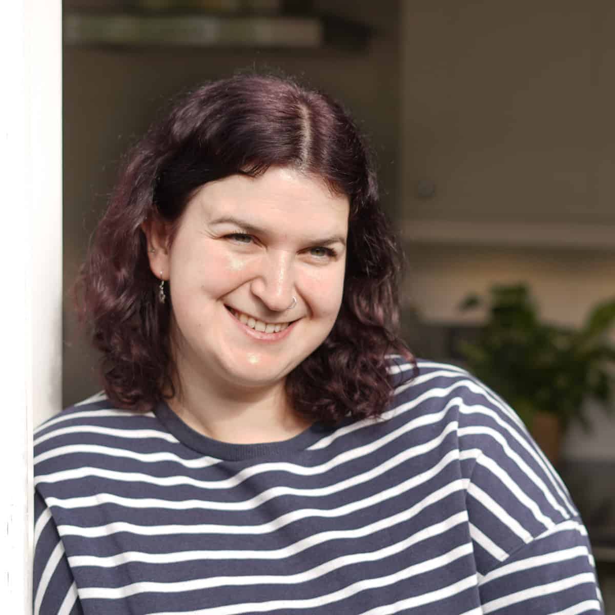 Vegetarian food blogger Becca Heyes in a stripy sweatshirt.