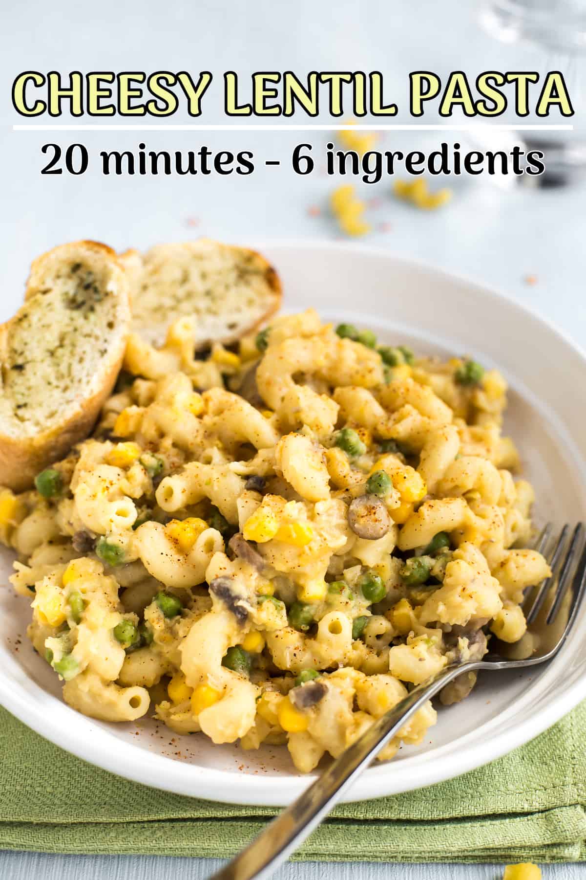 Portion of cheesy lentil pasta with peas and sweetcorn.
