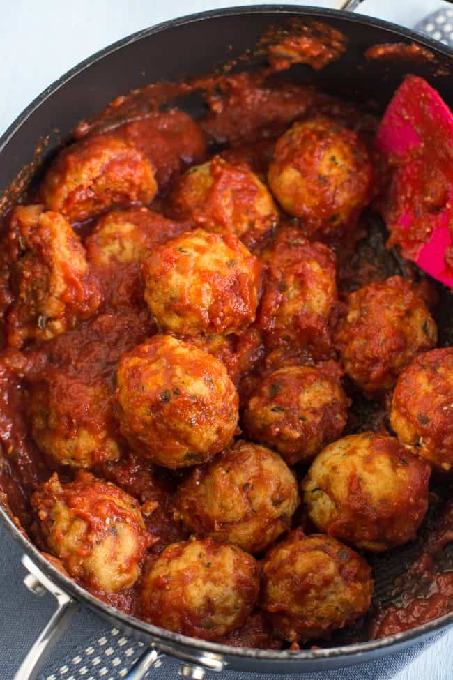 Cheesy tofu meatballs in tomato sauce in a frying pan