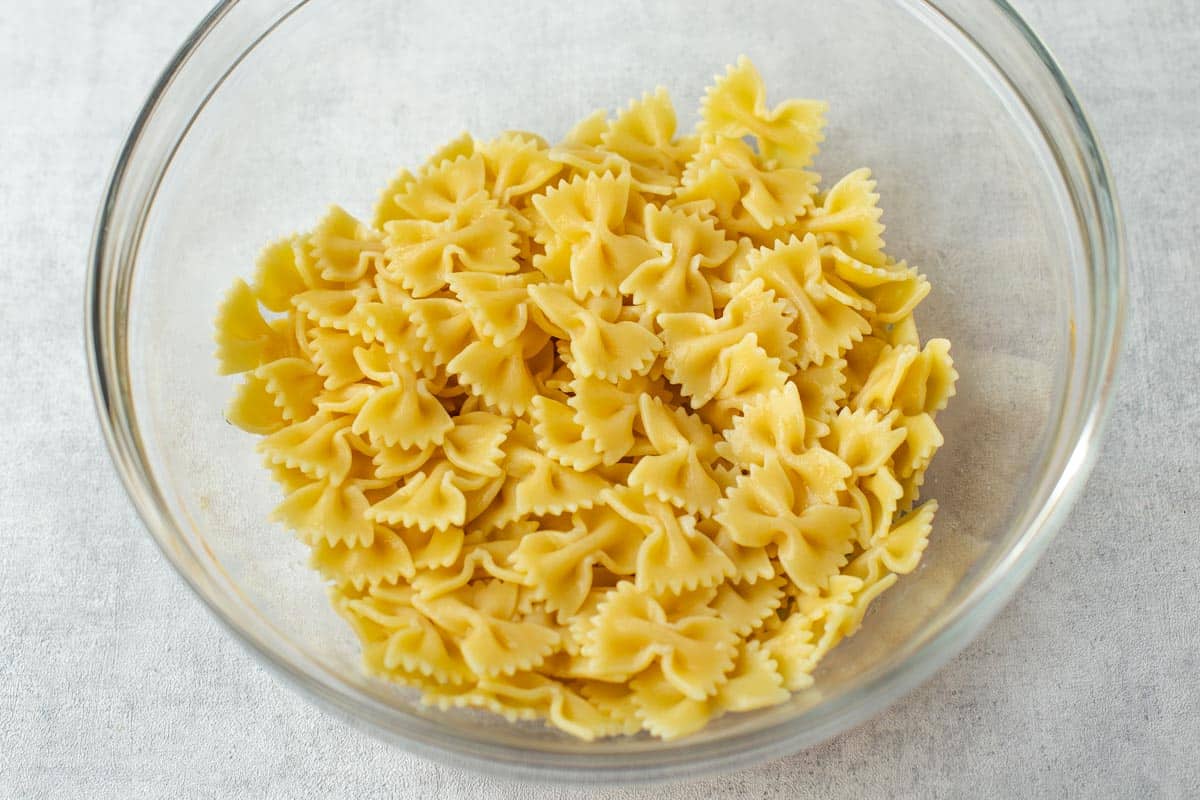 Cooked farfalle pasta in a mixing bowl.
