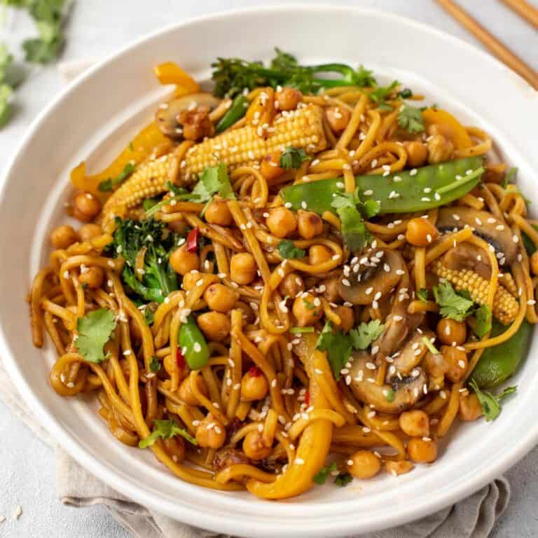 Chickpea stir fry in a bowl topped with sesame seeds.