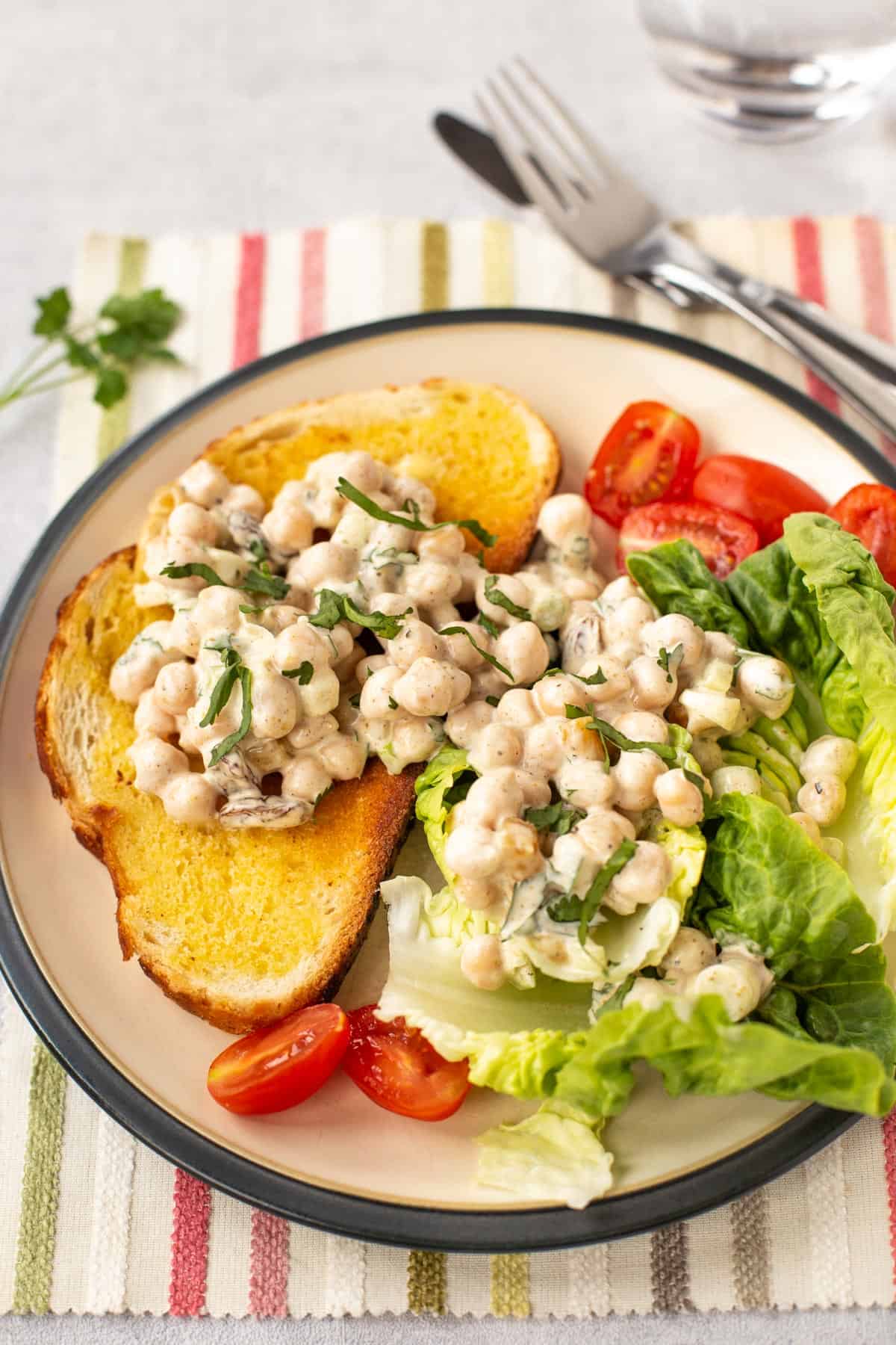 Creamy coronation chickpeas served on toast and lettuce.