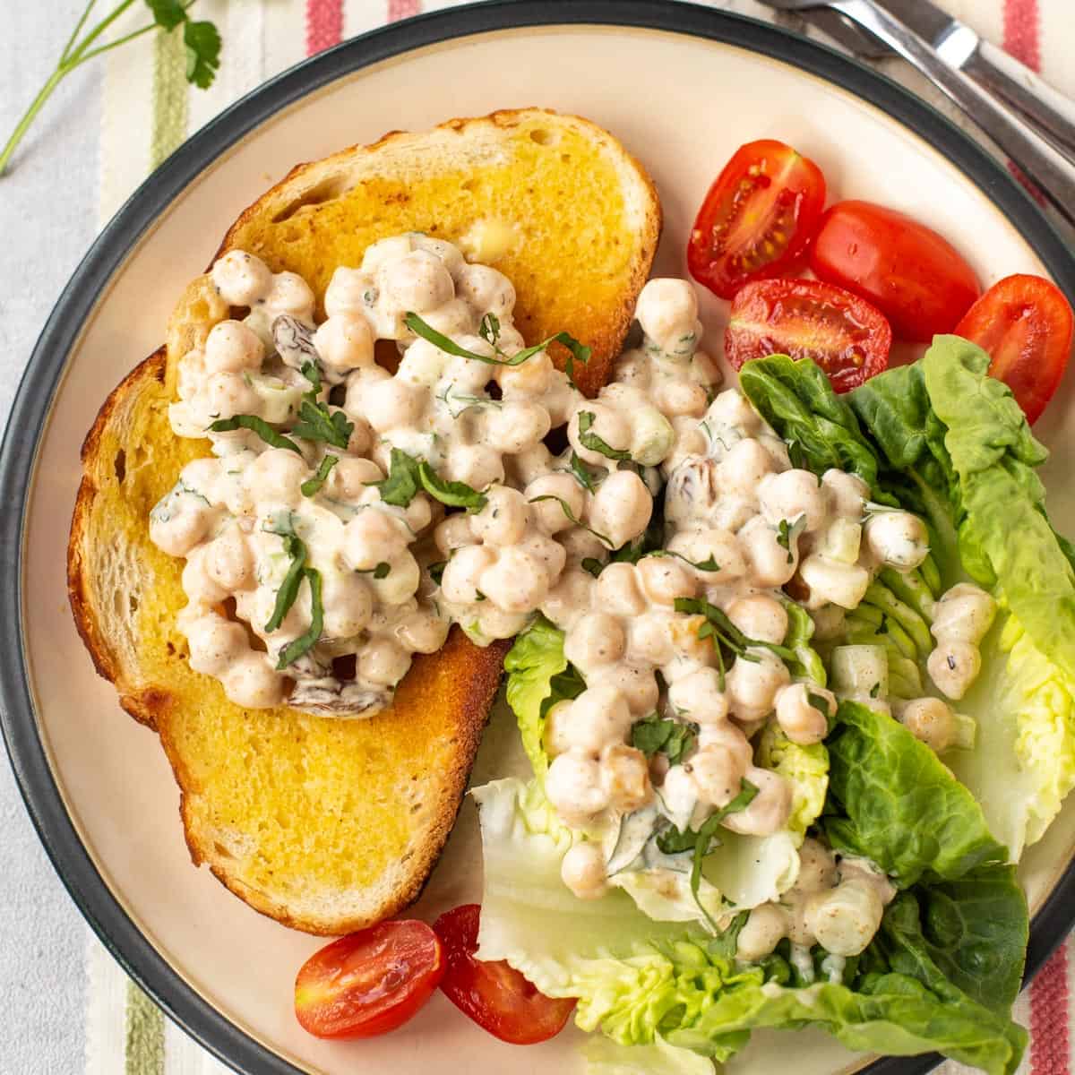 Creamy coronation chickpeas on toast and lettuce.