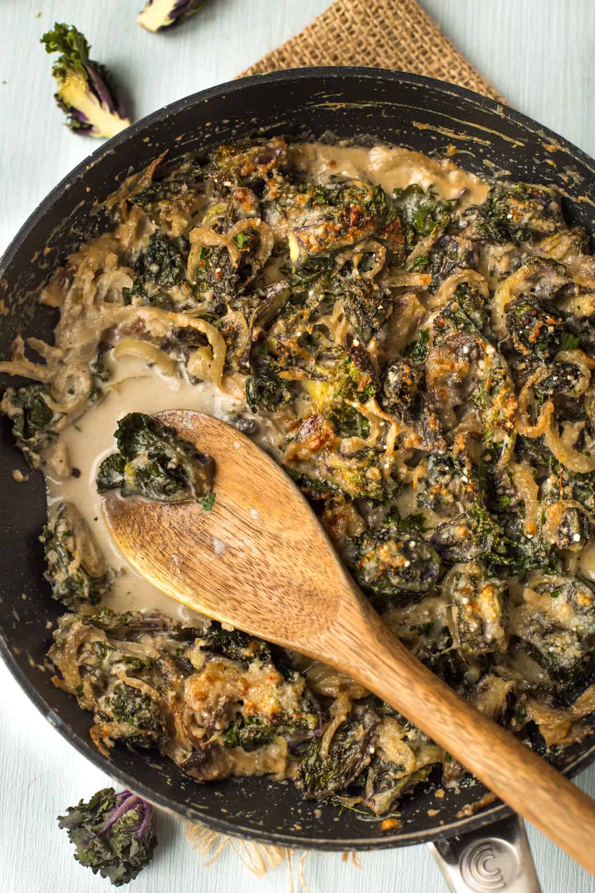 Creamed kalettes being scooped with a wooden spoon.