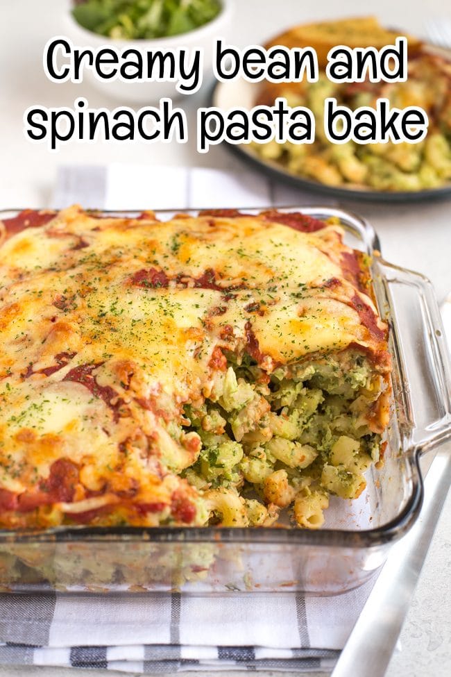 Cheesy pasta bake in a pyrex dish with a portion removed