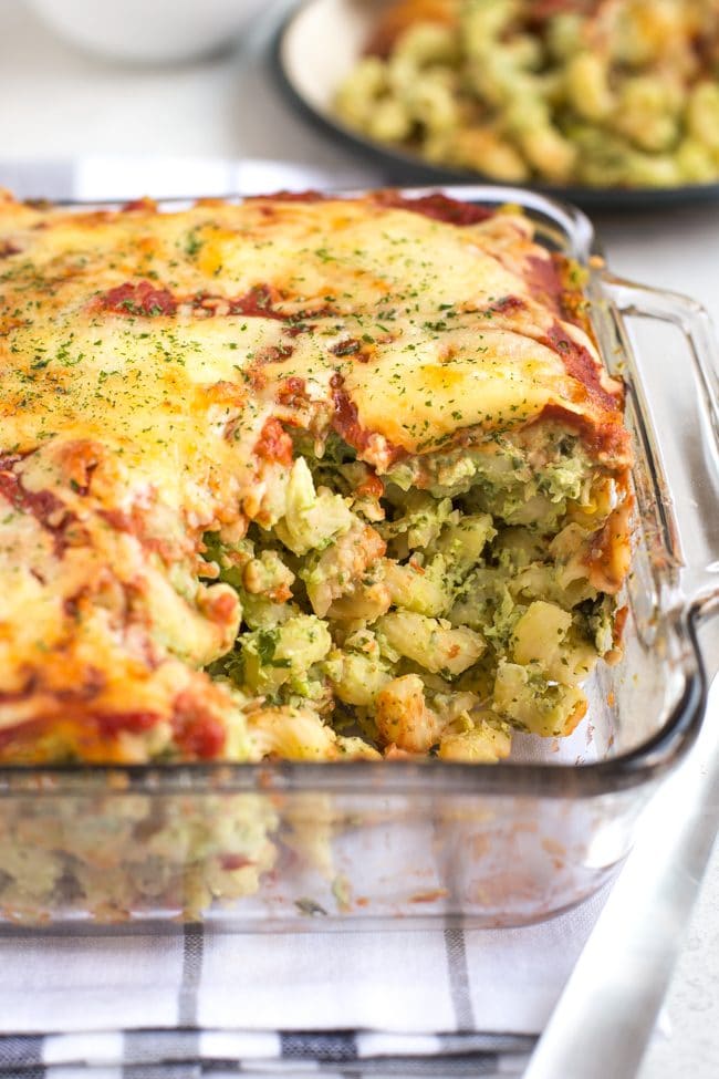 Cheesy pasta bake in a pyrex dish with a portion removed
