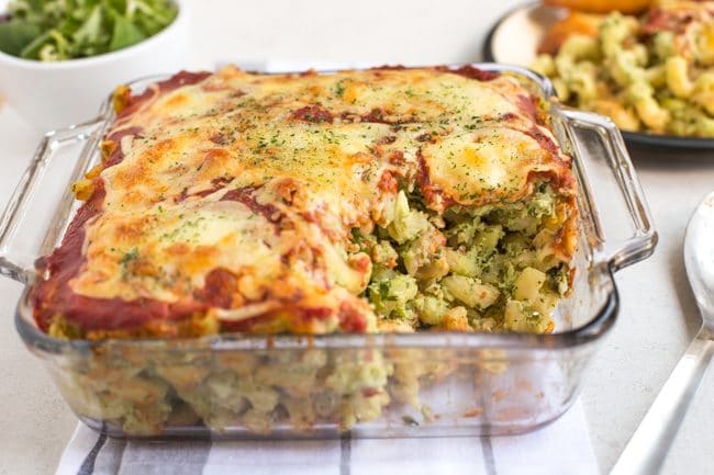Cheesy pasta bake in a pyrex dish with a portion removed