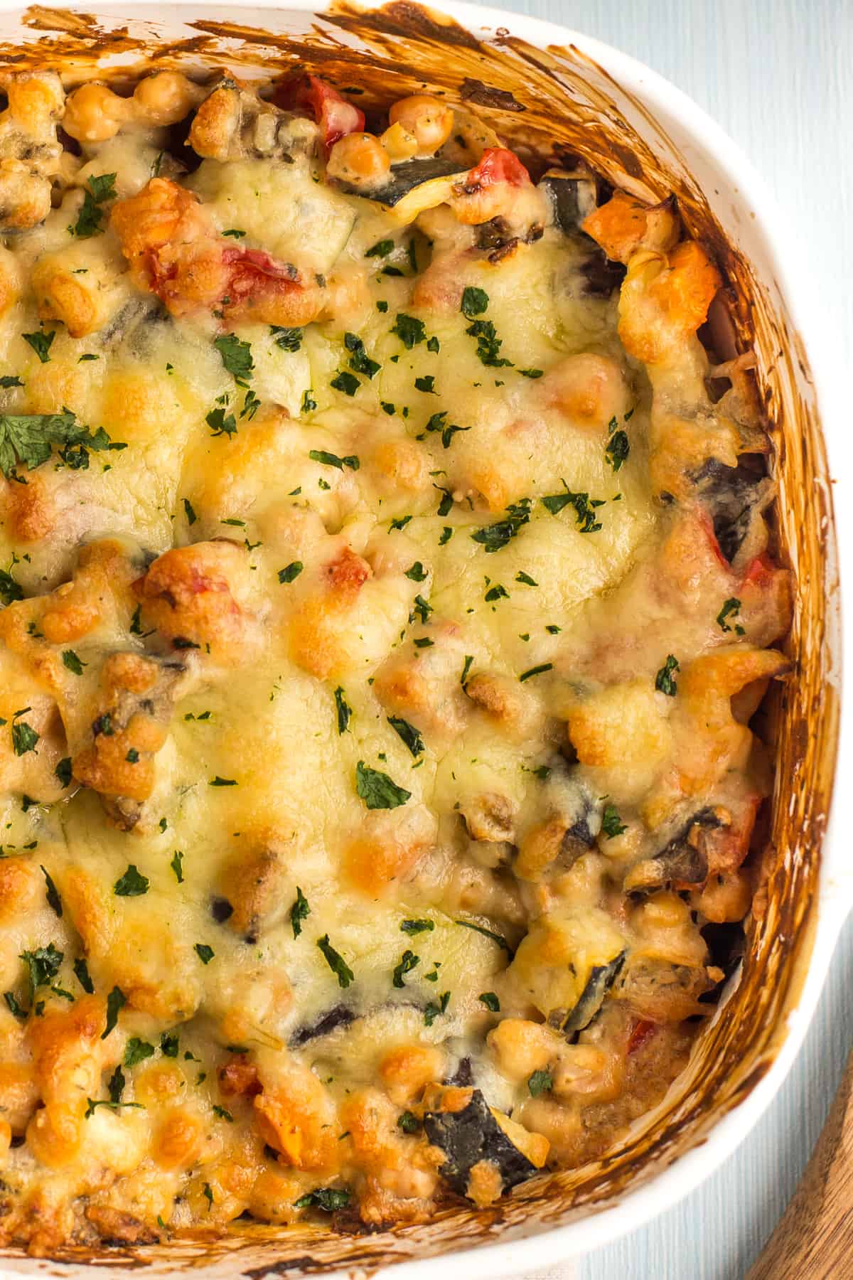 Close up of melted cheese on top of a creamy chickpea bake.