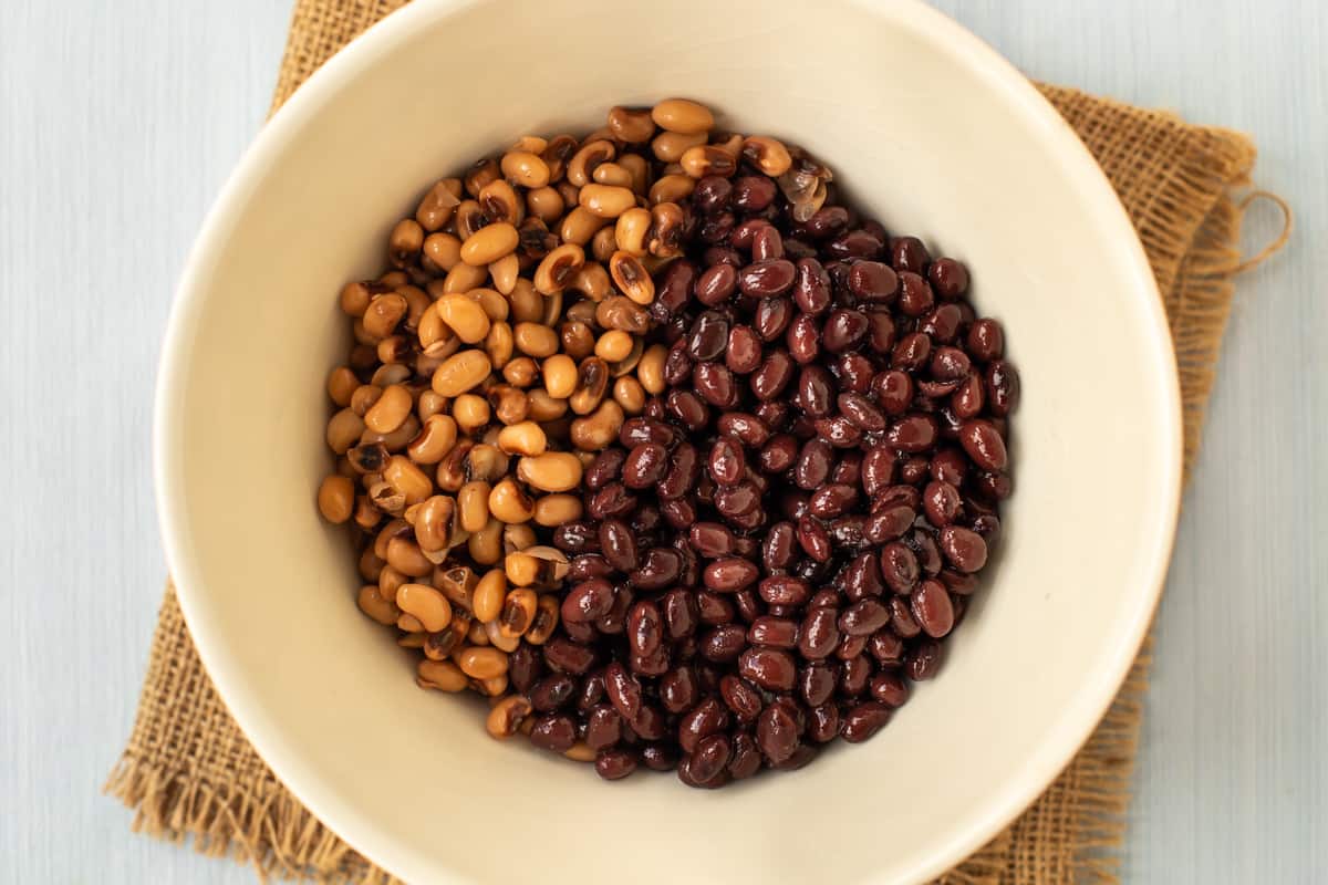 Black beans and black eyed beans in a mixing bowl.