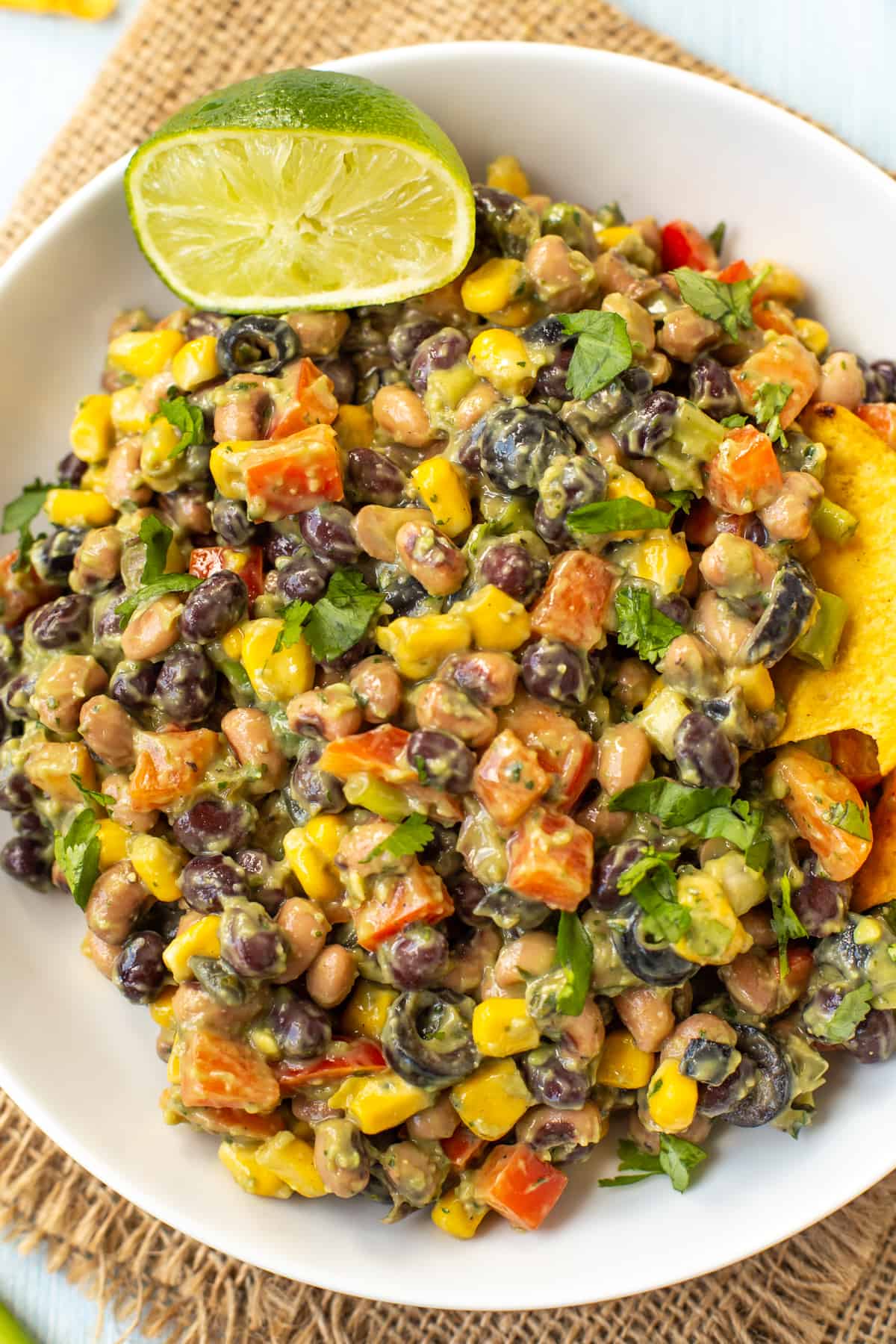 Close up shot of creamy cowboy caviar with black eyed beans and an avocado dressing.