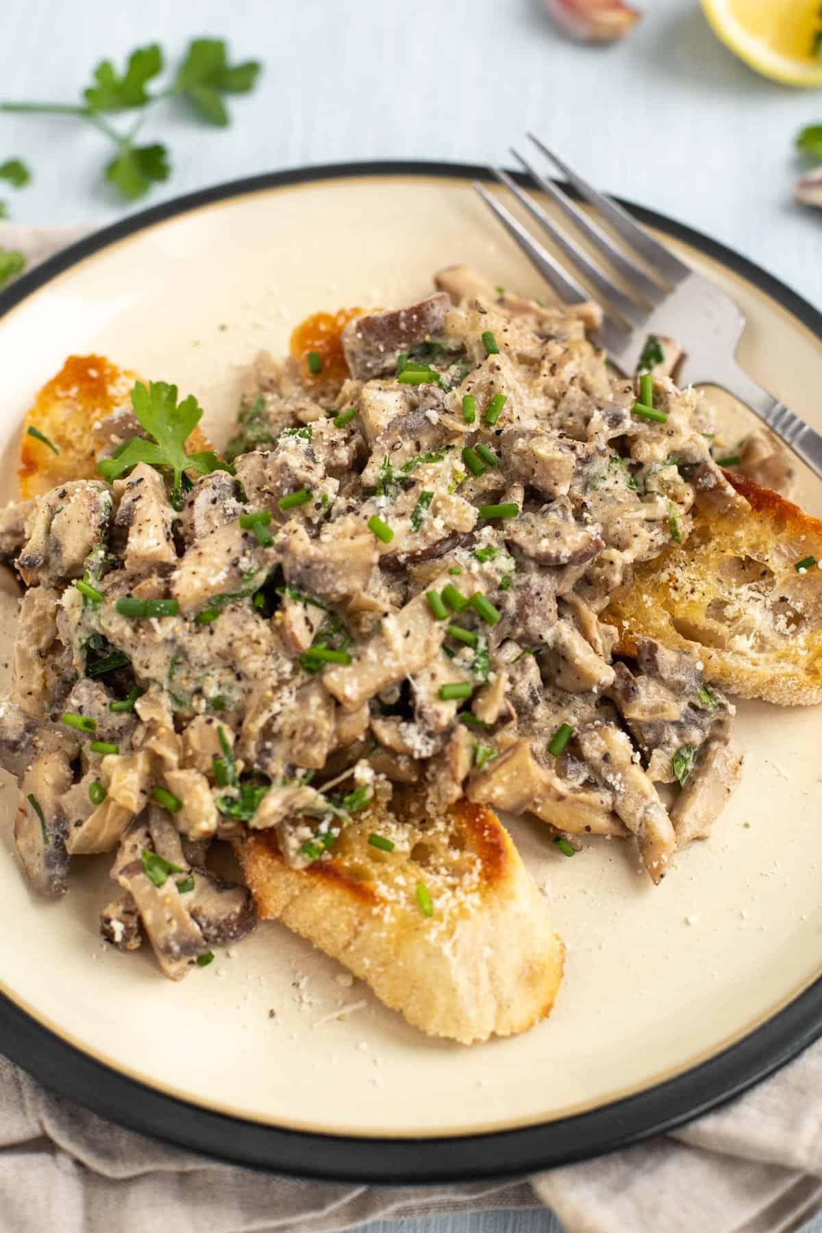 Creamy mushrooms on toast with fresh herbs.