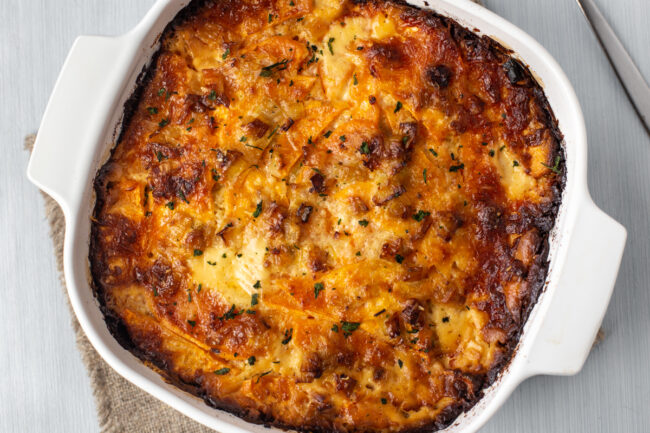 Crispy sweet potato gratin in a baking dish.