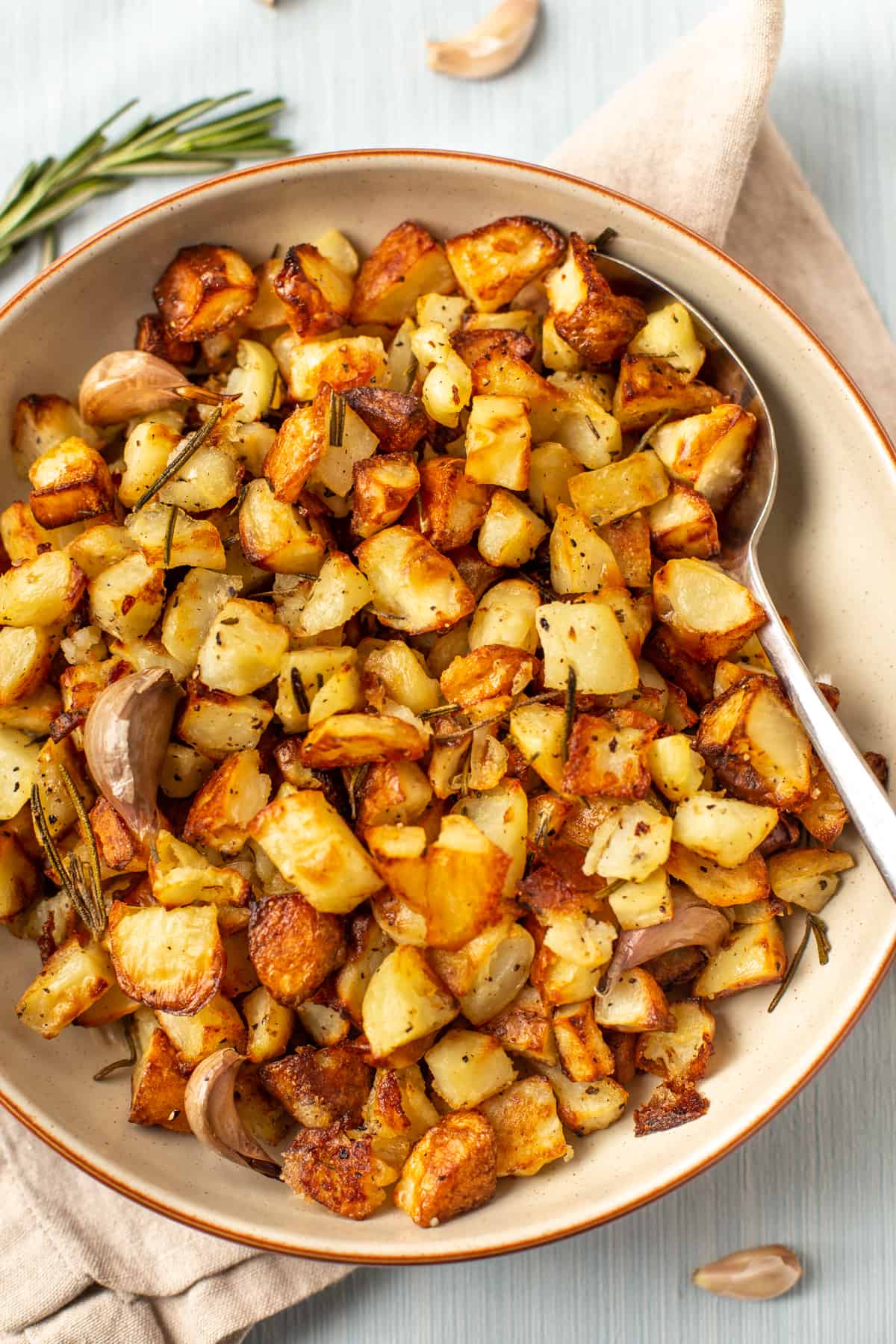 A bowl of Parmentier potatoes with roasted garlic and fresh rosemary.