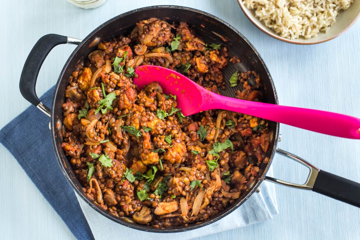 Lentil and halloumi curry being cooked in a pan