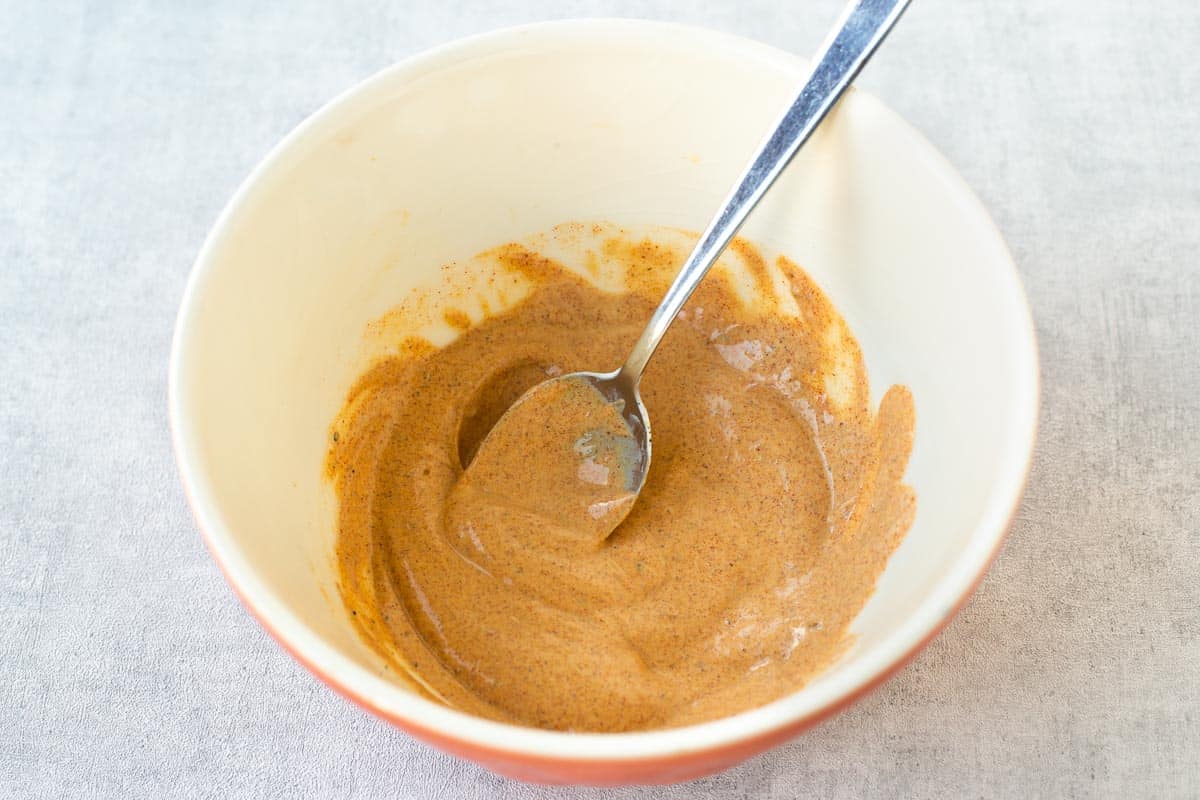 A spiced yogurt marinade in a mixing bowl.