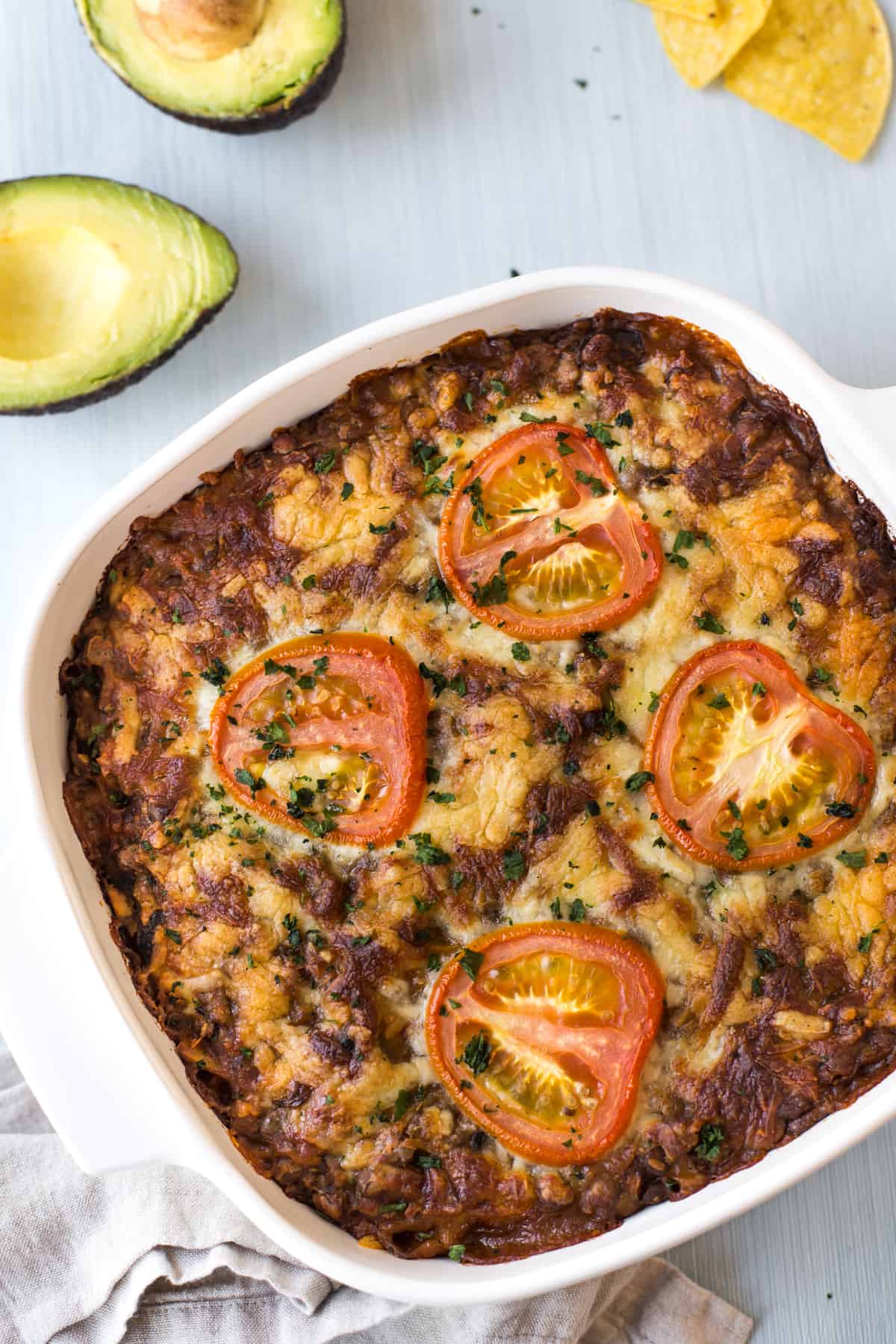 Cheese-topped lentil casserole in a baking dish.