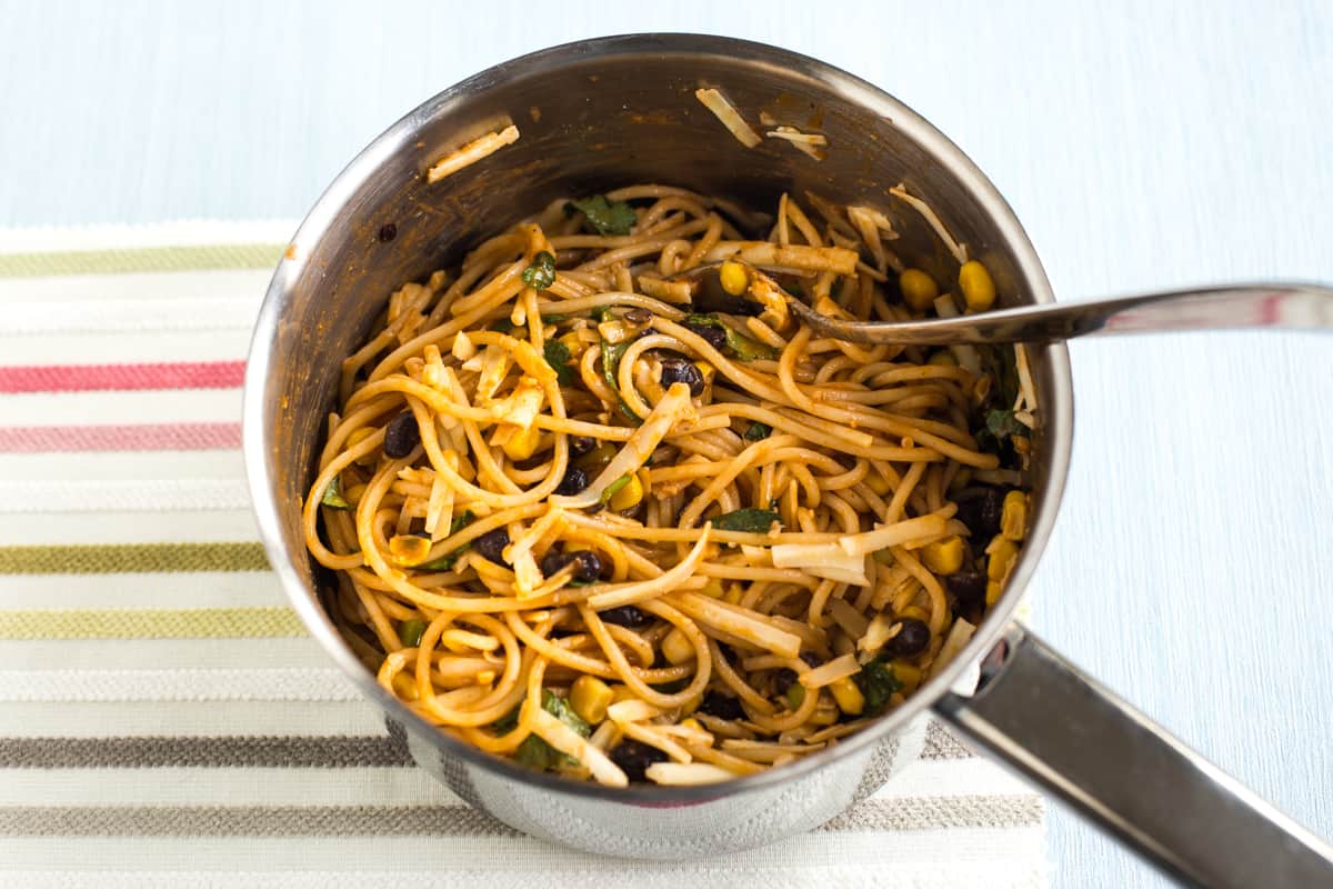 Cheesy enchilada noodles in a saucepan