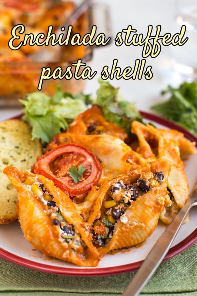 Portion of enchilada stuffed pasta shells on a plate with a fork