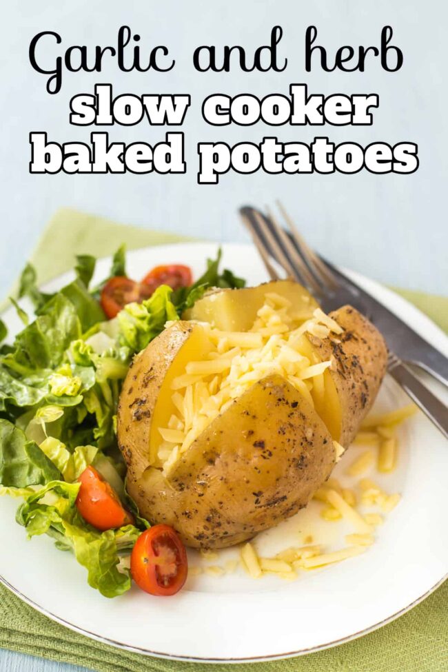A slow cooker baked potato topped with grated cheese, served with salad.