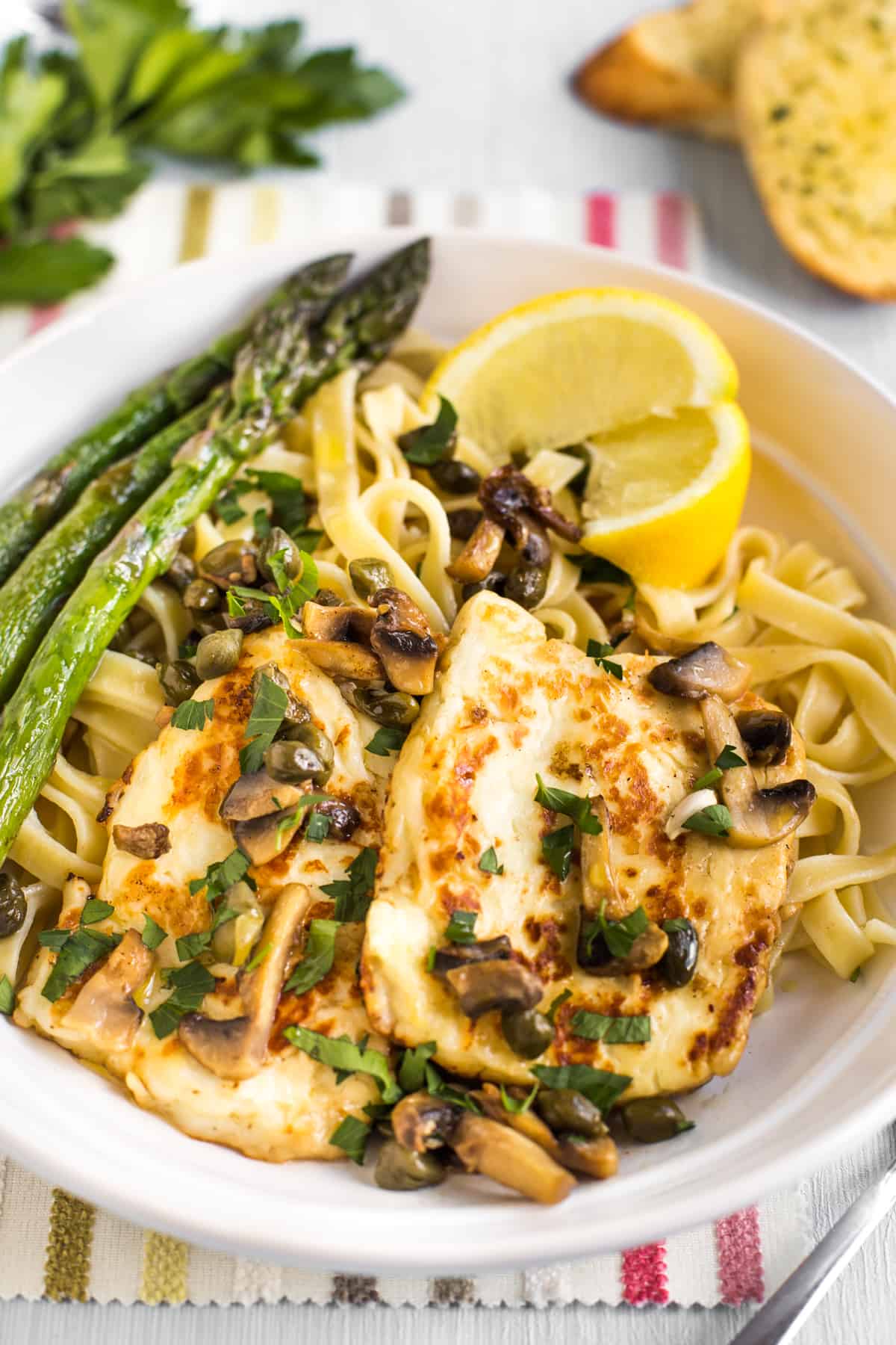 Portion of halloumi piccata served with tagliatelle and asparagus