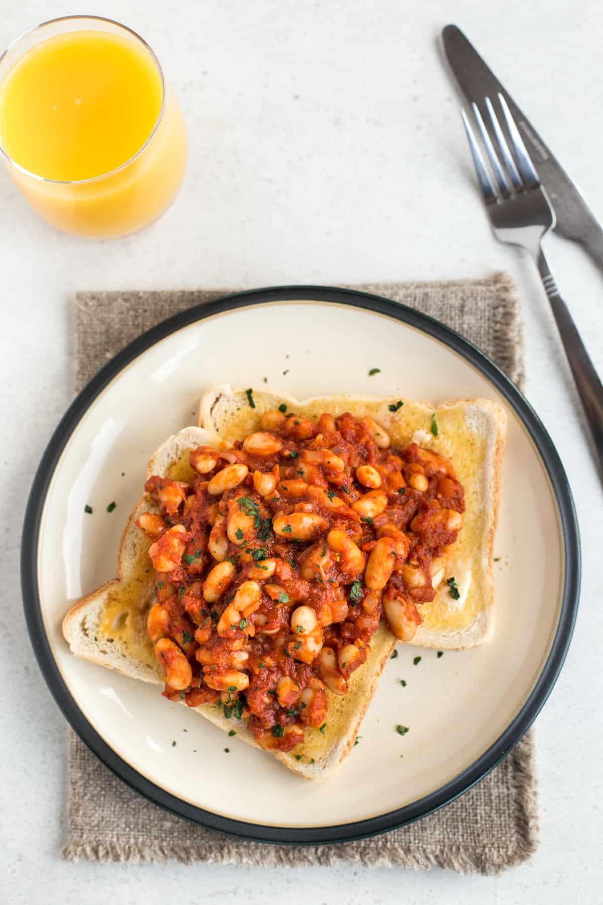 Two slices of toast topped with homemade baked beans.