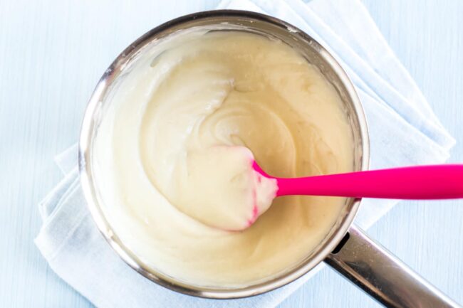 A thick and creamy white sauce in a saucepan