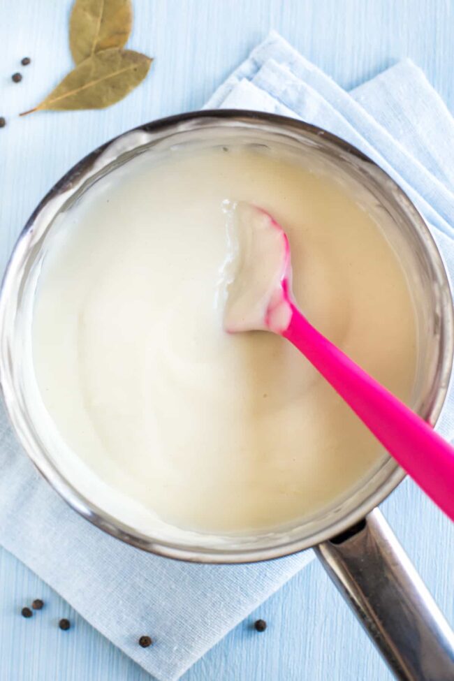 A creamy white sauce in a saucepan