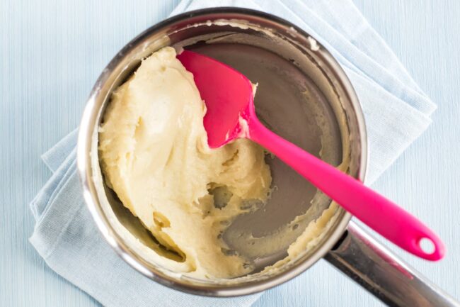 A very thick white sauce in a saucepan