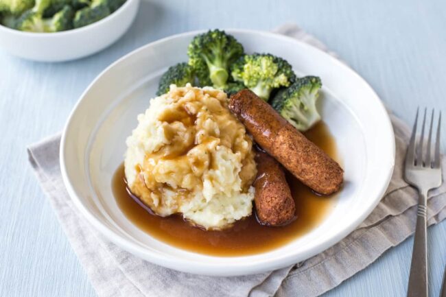 British-style bangers and mash with broccoli and gravy.