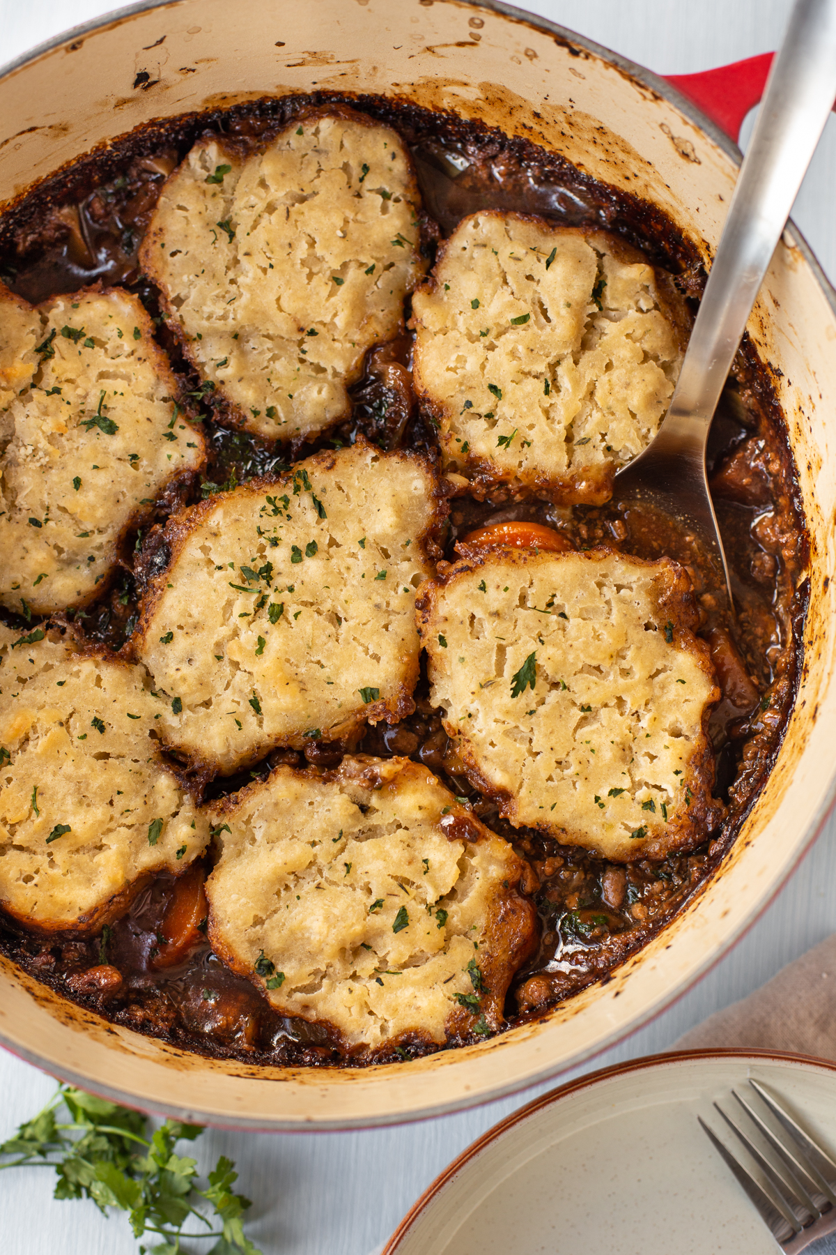 A large pot of vegetarian stew topped with suet dumplings.