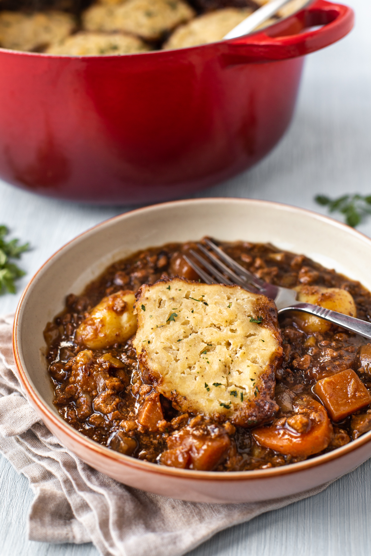 A bowl of vegetarian stew with a suet dumpling.