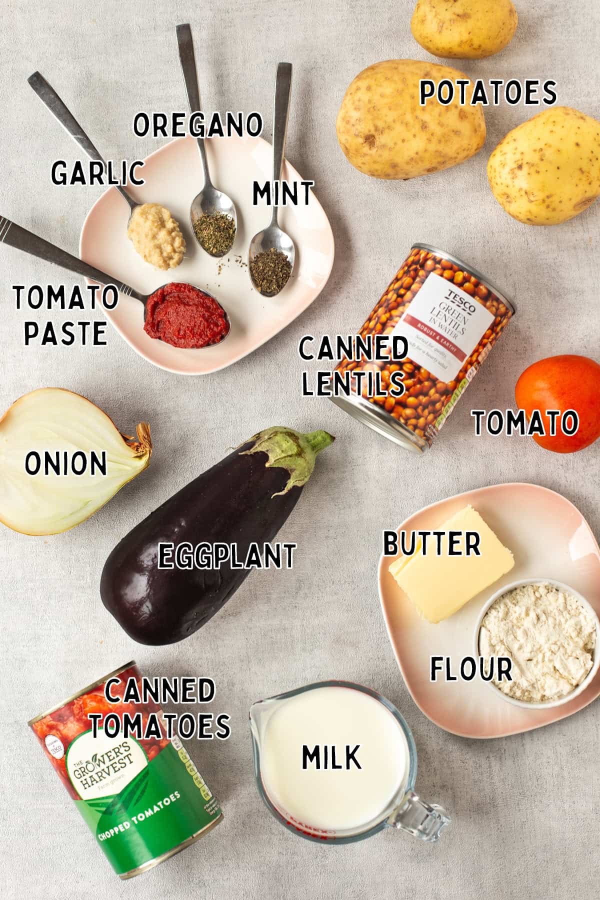 Ingredients for vegetable moussaka casserole laid out with text overlay.