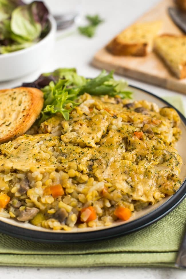 Portion of Instant Pot very veggie lentil bake on a plate with salad