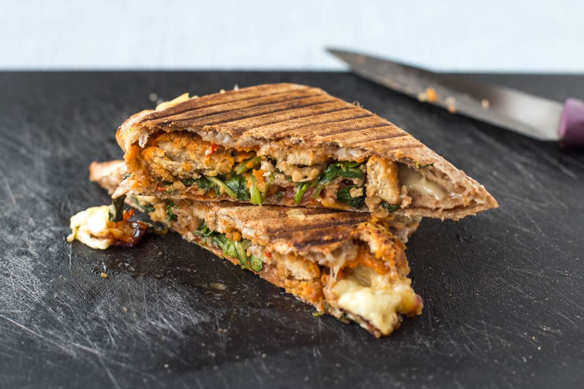 A grilled tortilla on a board with vegetarian nuggets and watercress.