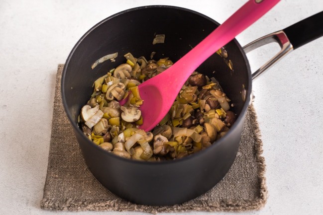 Garlic mushrooms and leeks cooking in a saucepan