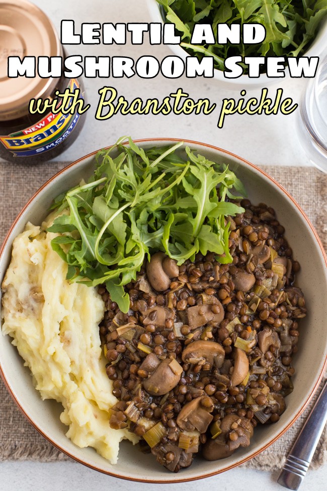 Portion of lentil and mushroom stew in a bowl with cheesy mashed potato and rocket