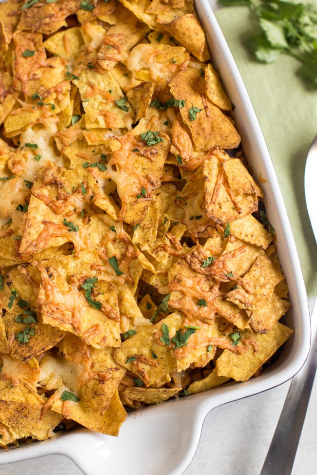 Nacho pasta bake - a creamy, spicy, vegetarian Mexican inspired pasta bake topped with tortilla chips and plenty of cheese!