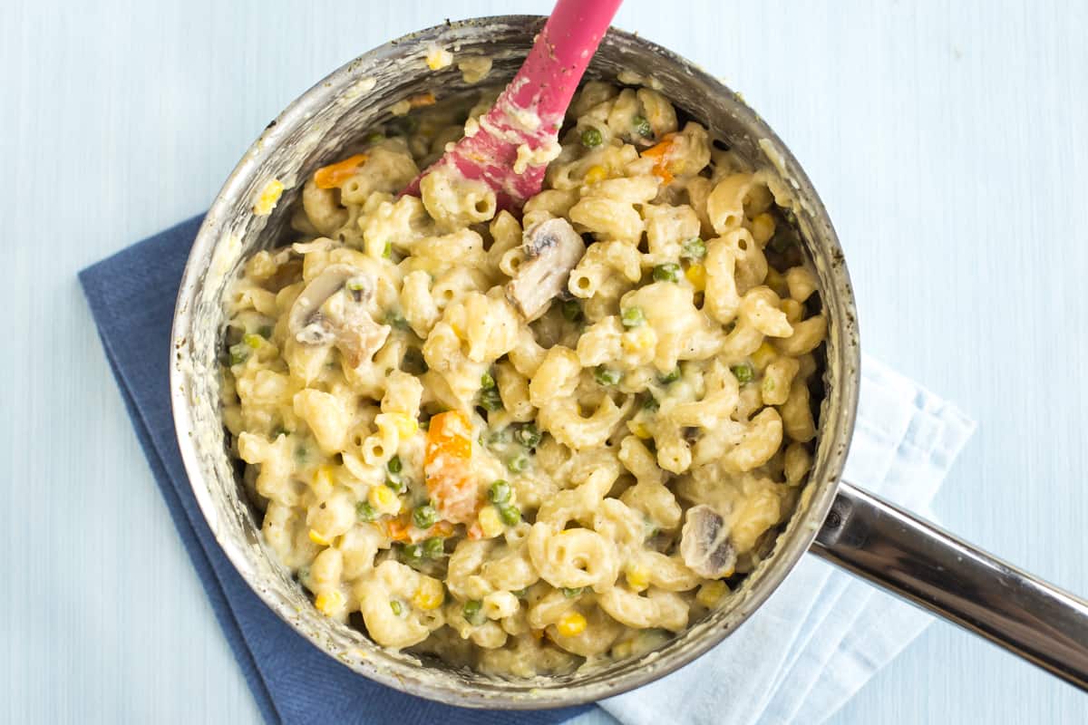 Creamy and cheesy veggie pasta in a saucepan.