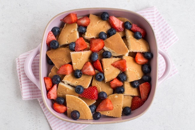 Pancakes and fresh berries in a baking dish