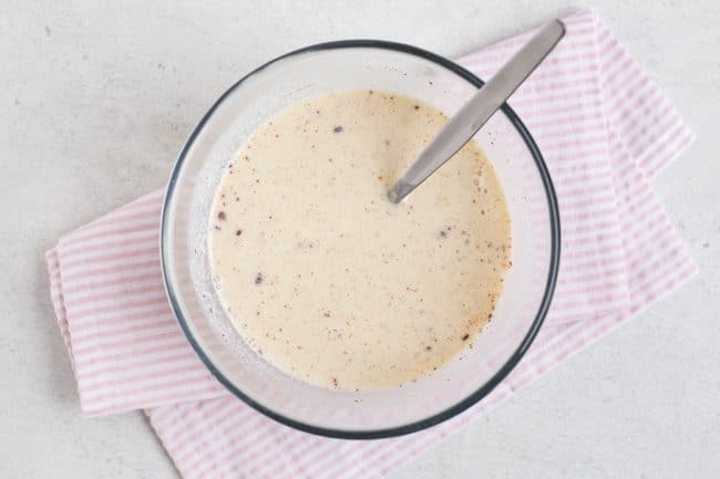 Simple egg custard in a bowl on a pink napkin