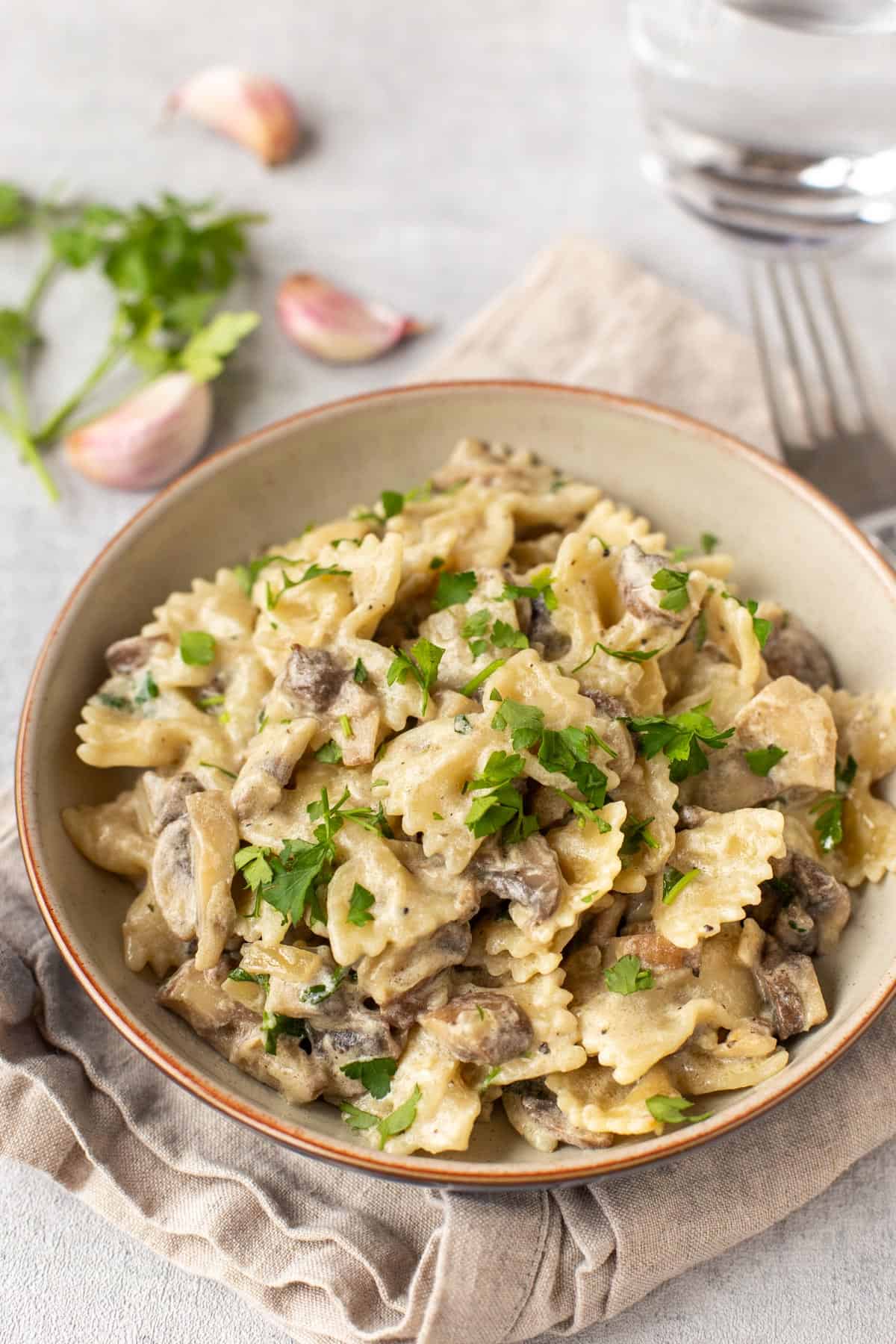 Creamy mushroom and white wine pasta in a bowl.